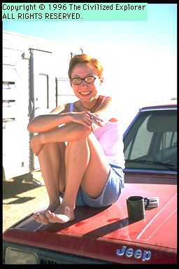 A young person sitting on a truck.