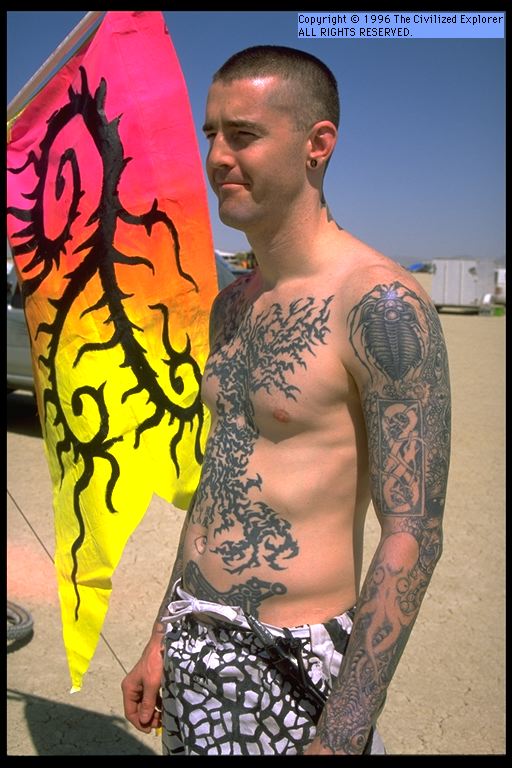 Baroque scrolling on his tattoos.