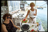 A waitress serves a beautiful salad.