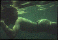 [Reflections of the water on a swimmer.]